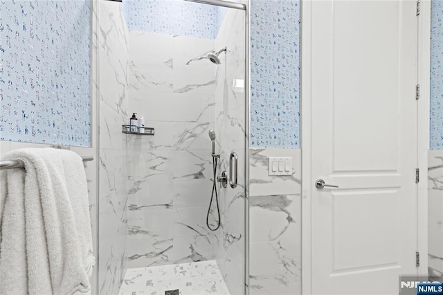 bathroom featuring a marble finish shower