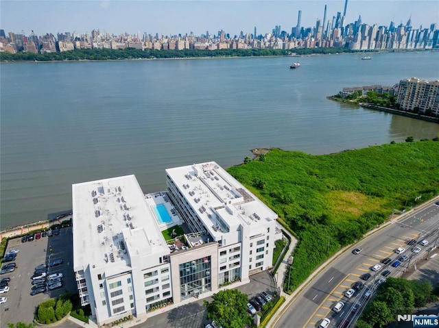 birds eye view of property featuring a water view and a view of city