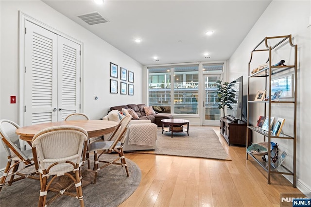 dining area featuring light wood-type flooring, visible vents, and recessed lighting