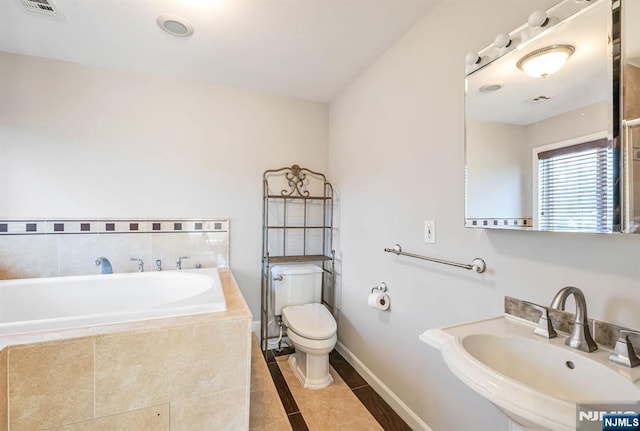 bathroom with tile patterned flooring, visible vents, toilet, a bath, and a sink