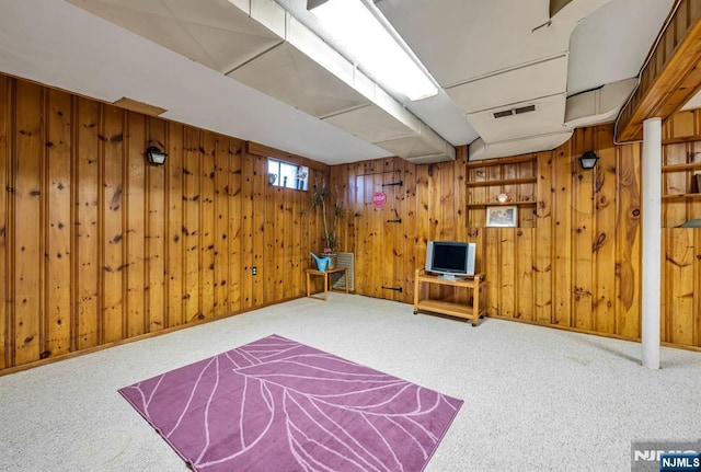 interior space with visible vents, wooden walls, and carpet flooring