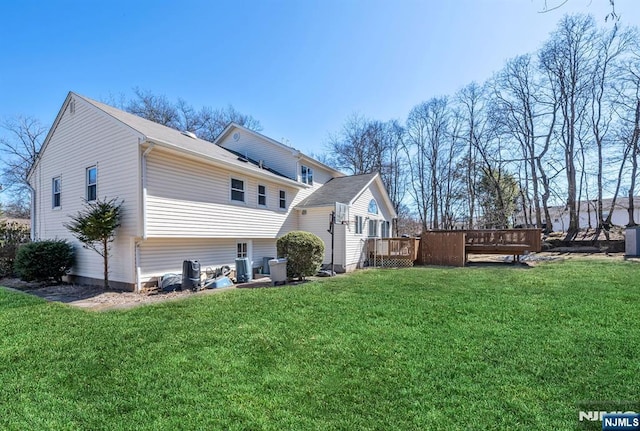 back of house featuring a yard, central AC unit, and a deck