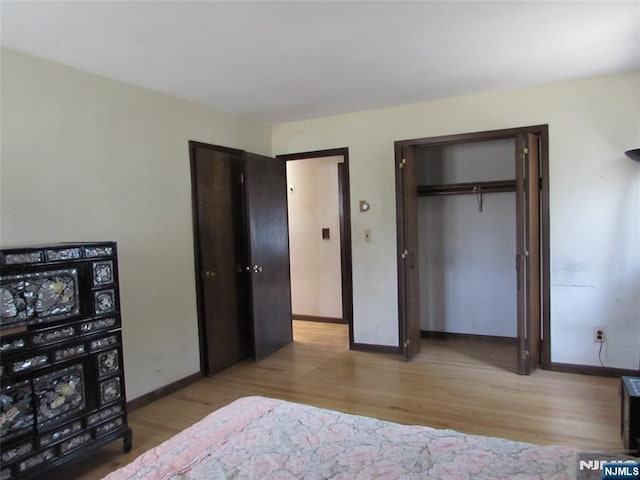 bedroom featuring light wood-type flooring and baseboards