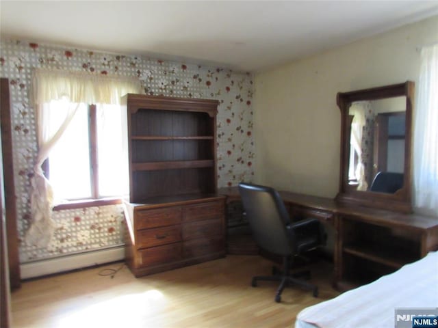 home office featuring light wood-type flooring and a baseboard radiator