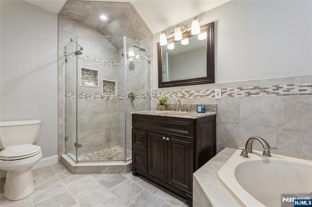 full bathroom with a garden tub, toilet, vanity, tile walls, and a shower stall