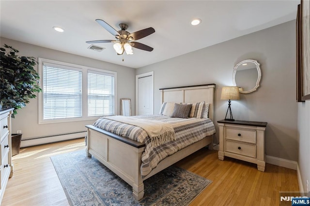 bedroom featuring baseboards, visible vents, baseboard heating, light wood-style floors, and recessed lighting