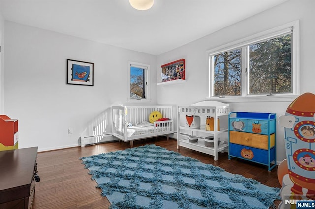 bedroom featuring baseboards and wood finished floors