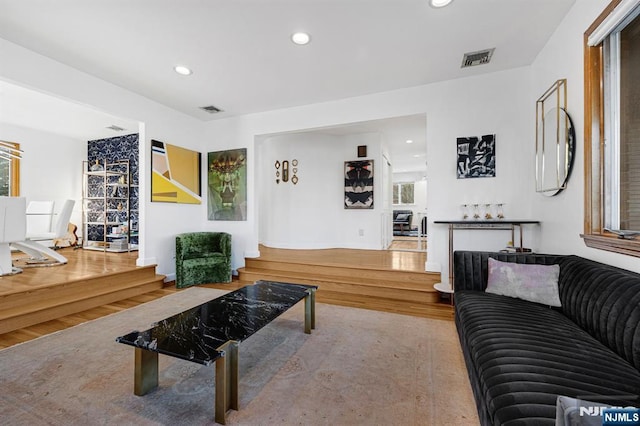 living room featuring recessed lighting, visible vents, and wood finished floors