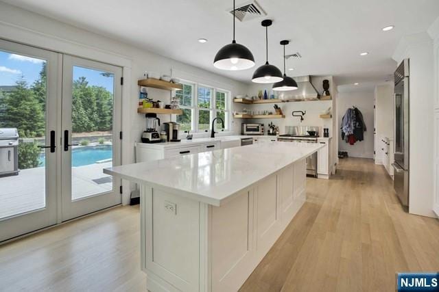 kitchen featuring visible vents, french doors, light wood-type flooring, stainless steel range with electric stovetop, and open shelves