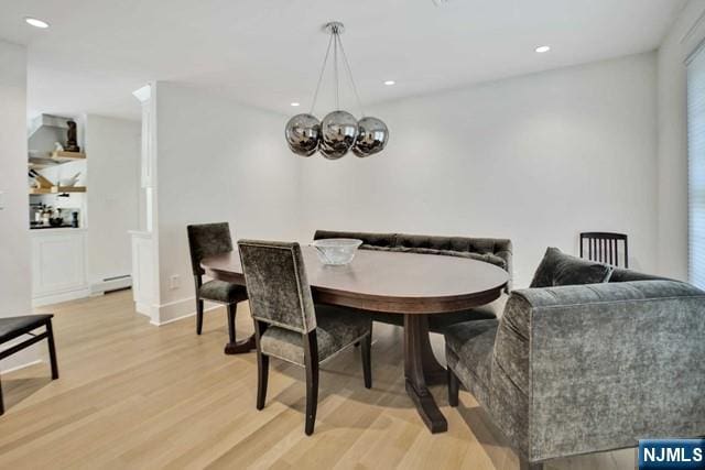 dining room featuring light wood-style flooring, a chandelier, and recessed lighting