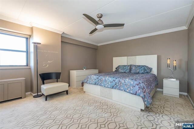 carpeted bedroom with ceiling fan, baseboards, and ornamental molding