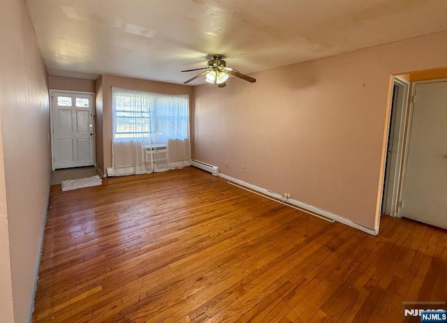 entryway with a baseboard heating unit, baseboards, ceiling fan, and hardwood / wood-style flooring