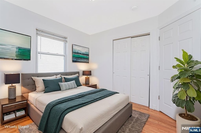 bedroom with a closet and light wood-style flooring