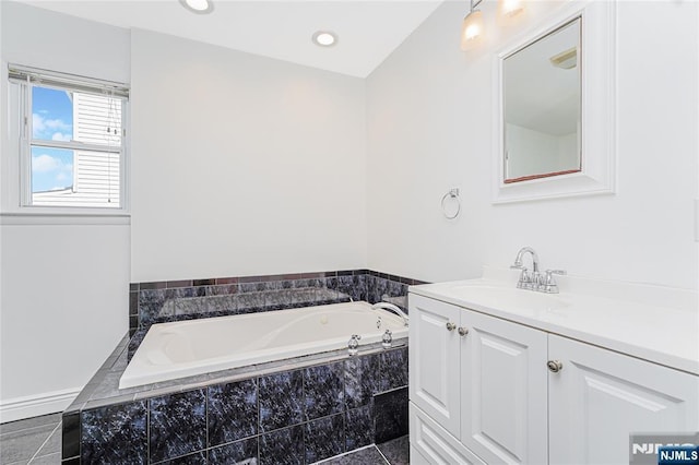 full bathroom with a garden tub, recessed lighting, and vanity