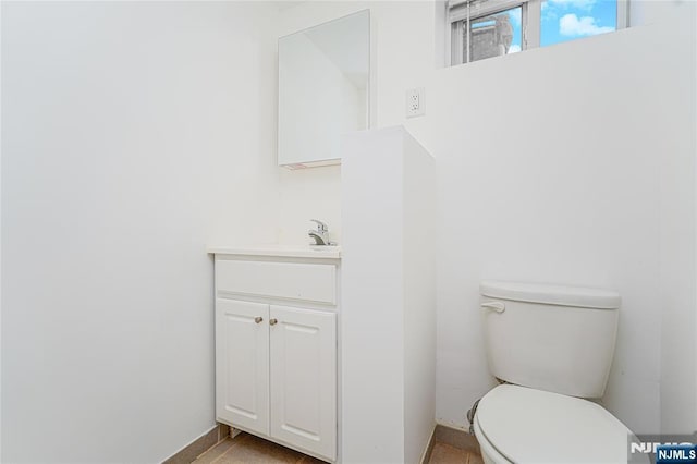 half bath featuring toilet and vanity