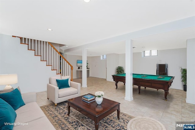 interior space featuring light tile patterned flooring, pool table, and stairs