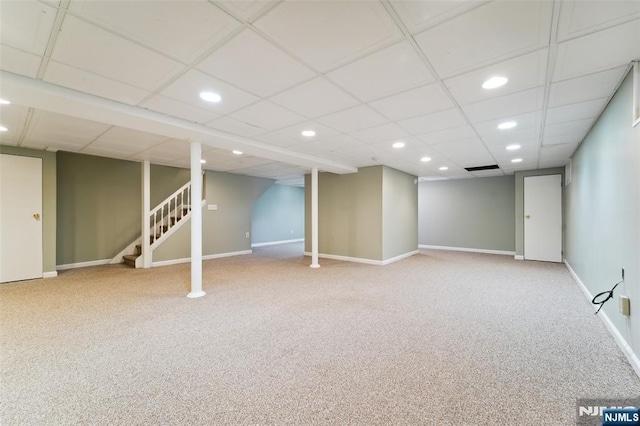 finished below grade area featuring stairs, baseboards, carpet flooring, and recessed lighting