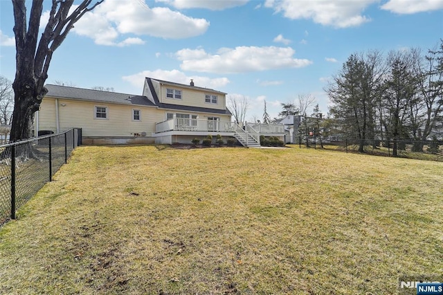 rear view of house with a deck, a yard, a fenced backyard, and stairs