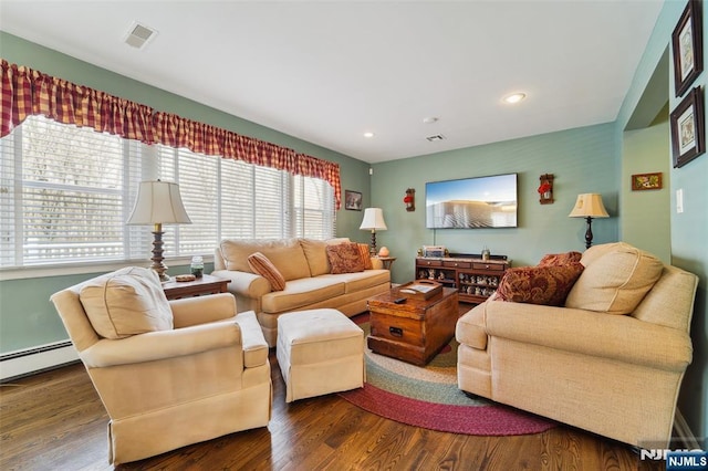 living room featuring a baseboard heating unit, wood finished floors, visible vents, and recessed lighting