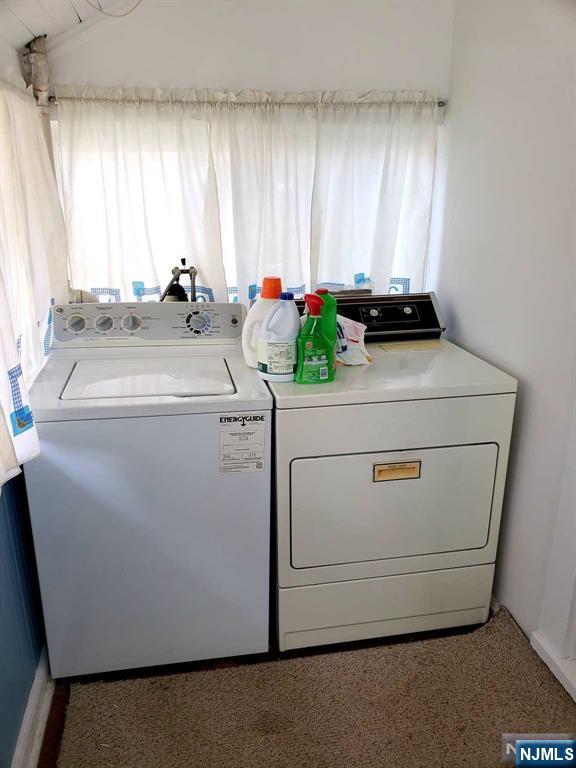 washroom featuring laundry area and washer and dryer