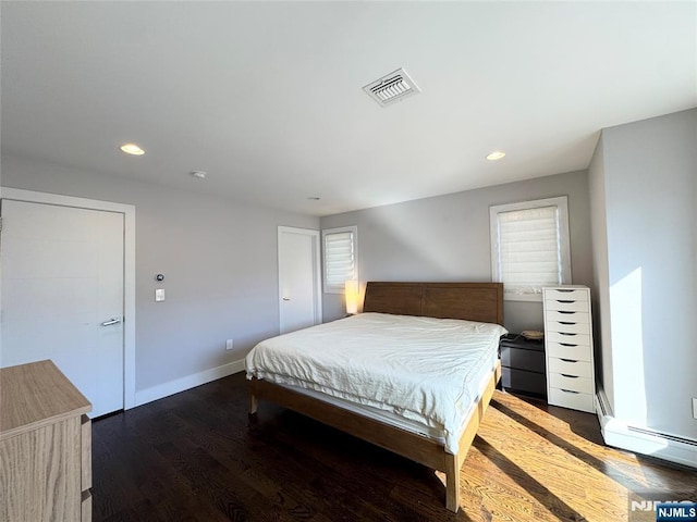 bedroom featuring baseboards, visible vents, dark wood-type flooring, and recessed lighting