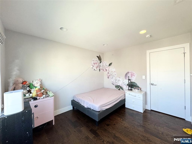 bedroom with recessed lighting, baseboards, and wood finished floors