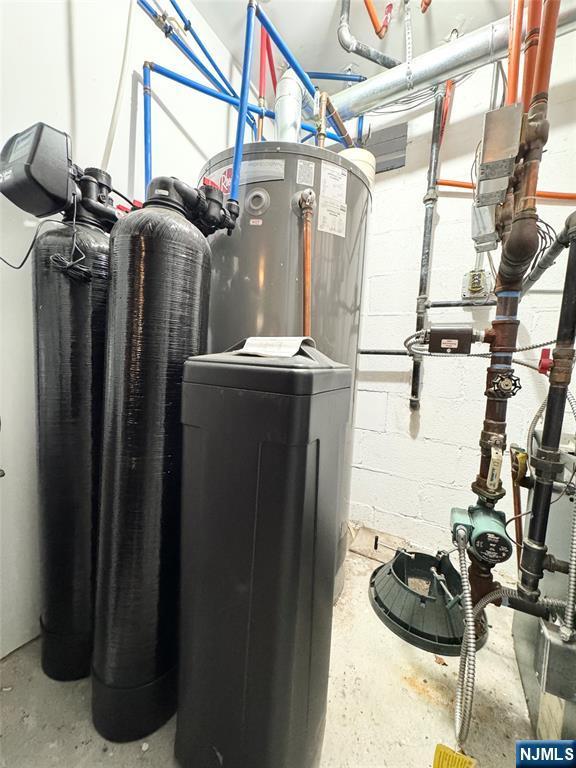 utility room featuring water heater