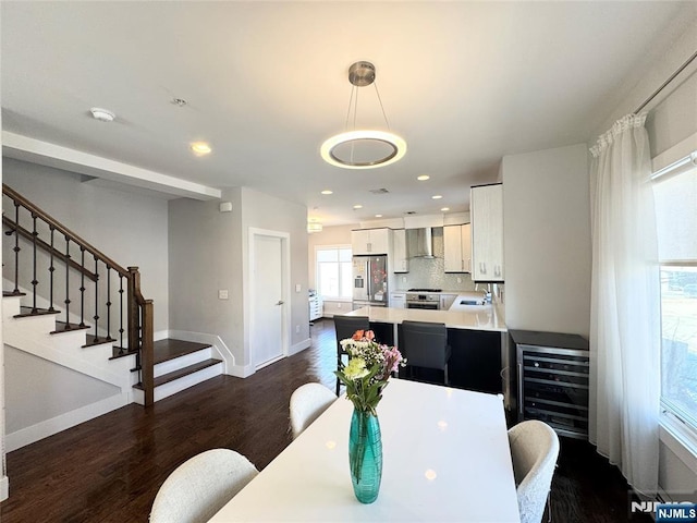 dining room with dark wood-type flooring, recessed lighting, stairway, and baseboards