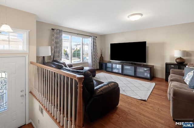 living room featuring baseboards and wood finished floors