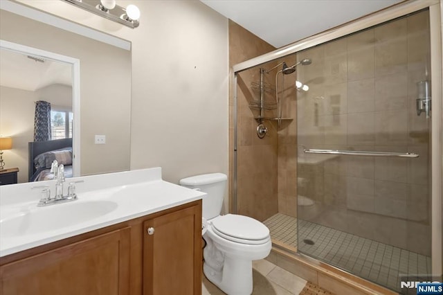 ensuite bathroom featuring ensuite bathroom, tile patterned flooring, vanity, and a shower stall