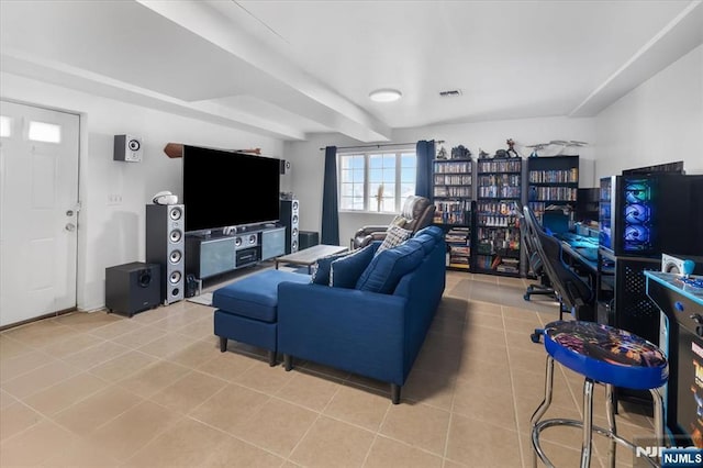 living area featuring light tile patterned floors and visible vents