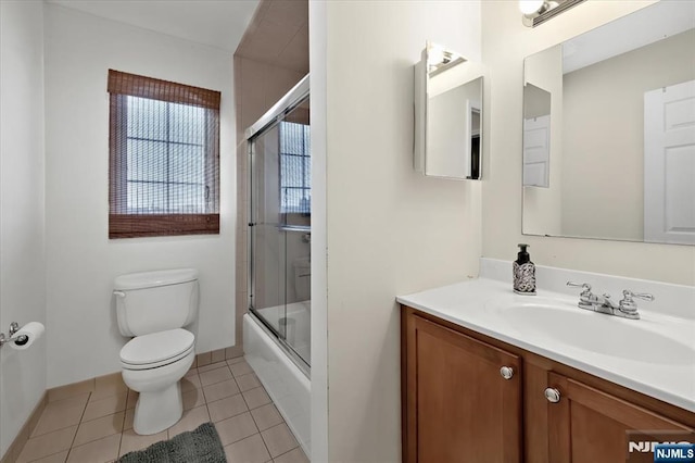 full bath featuring baseboards, toilet, enclosed tub / shower combo, tile patterned floors, and vanity