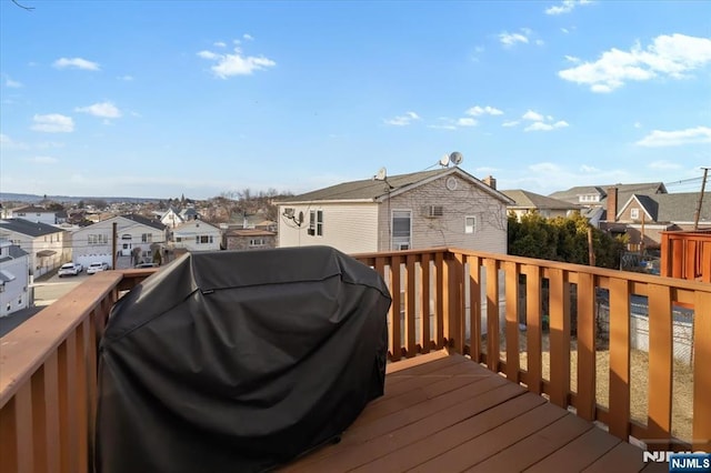 deck with a residential view and area for grilling