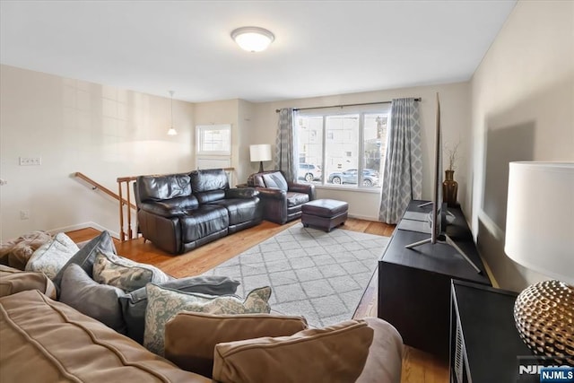 living room with light wood finished floors and baseboards