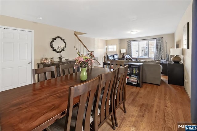 dining area featuring stairway and wood finished floors