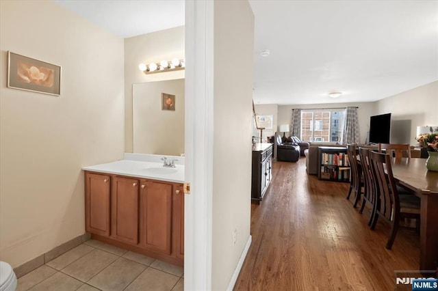 bathroom with baseboards and vanity