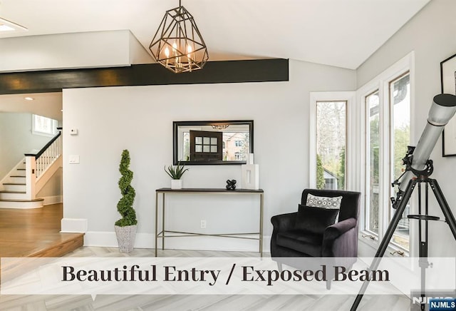 living area with lofted ceiling, plenty of natural light, stairway, and a chandelier