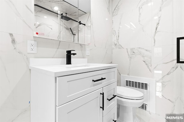 bathroom with a marble finish shower, toilet, radiator heating unit, vanity, and tile walls