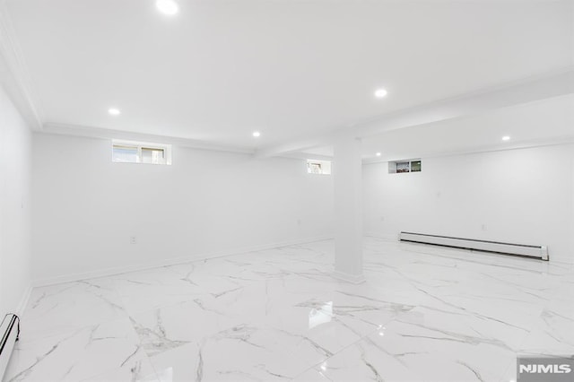 basement with marble finish floor, baseboard heating, recessed lighting, and baseboards