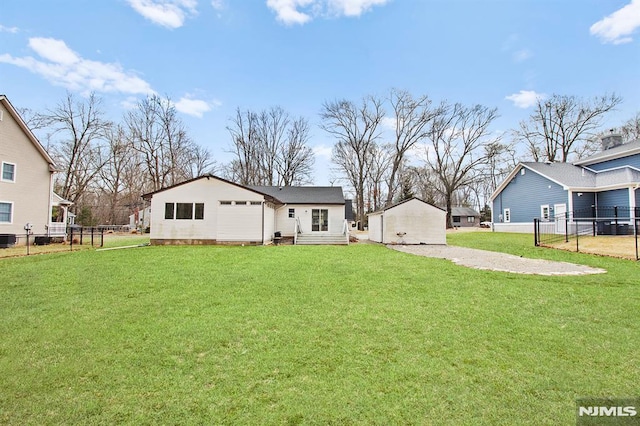 back of property with fence and a yard