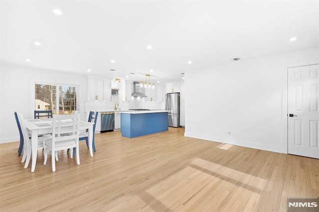 unfurnished dining area featuring baseboards, recessed lighting, visible vents, and light wood-style floors