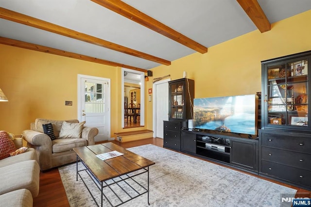 living area with beamed ceiling and wood finished floors