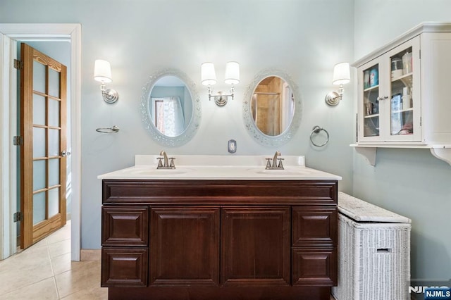 bathroom featuring double vanity, tile patterned flooring, and a sink