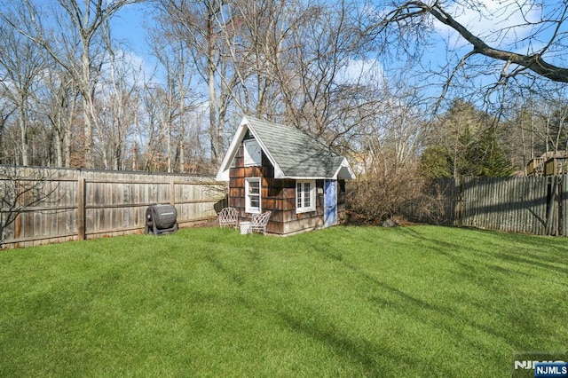 view of yard with an outbuilding and a fenced backyard