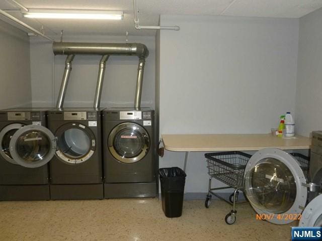 shared laundry area with washer and clothes dryer