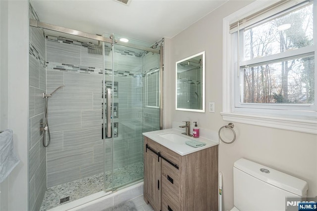 full bath with toilet, a shower stall, and vanity