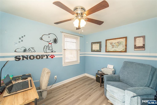 office space featuring wood finished floors, a ceiling fan, and baseboards