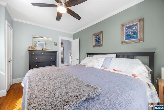 bedroom featuring ornamental molding, ceiling fan, baseboards, and wood finished floors