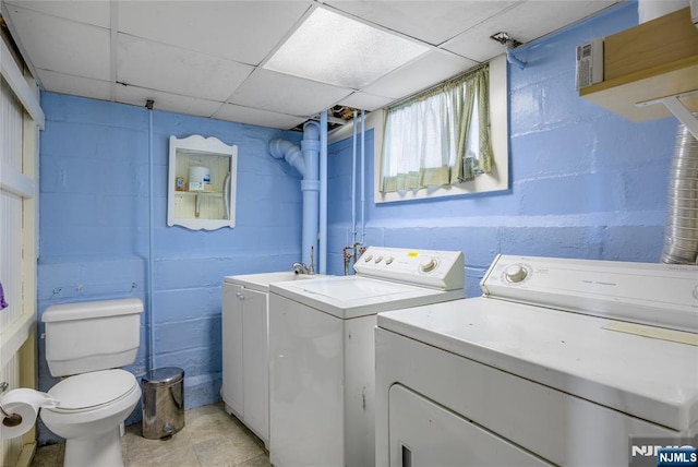 laundry area featuring laundry area, independent washer and dryer, and concrete block wall