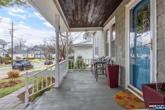 deck with a residential view and a porch